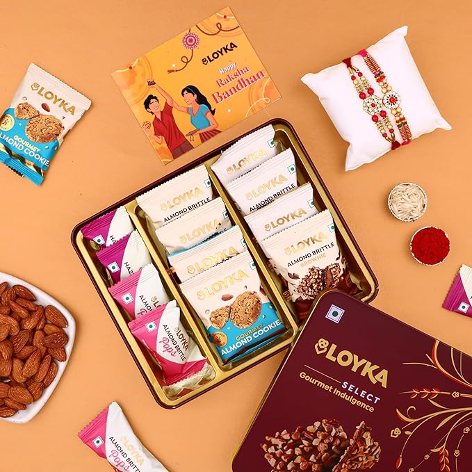 Loyka Select Majestic Maroon Tin (Reusable) With 2 Rakhi, Roli, Chawal, Card – 3 Almond Brittle Gold, 3 Brownie, 4 Pops, 2 Almond Cookies – A Premium Treat Box for Gifting & Indulgence (Assorted Rakhi)